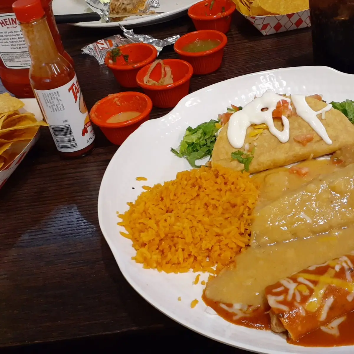 Clockwise from the Top Crispy Ground Beef Taco Chicken Enchilada Chile Relleno Beans and Rice