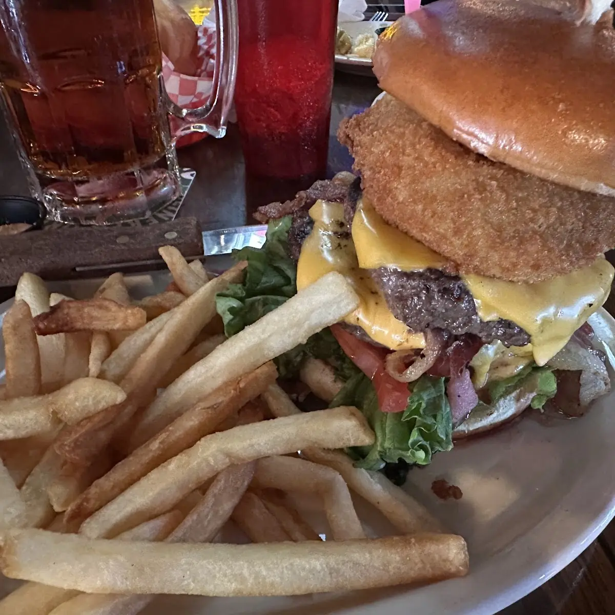 Cody's 1lb Steak Burger with American Cheese Bacon and Our Famous Hand Breaded Jumbo Onion Ring
