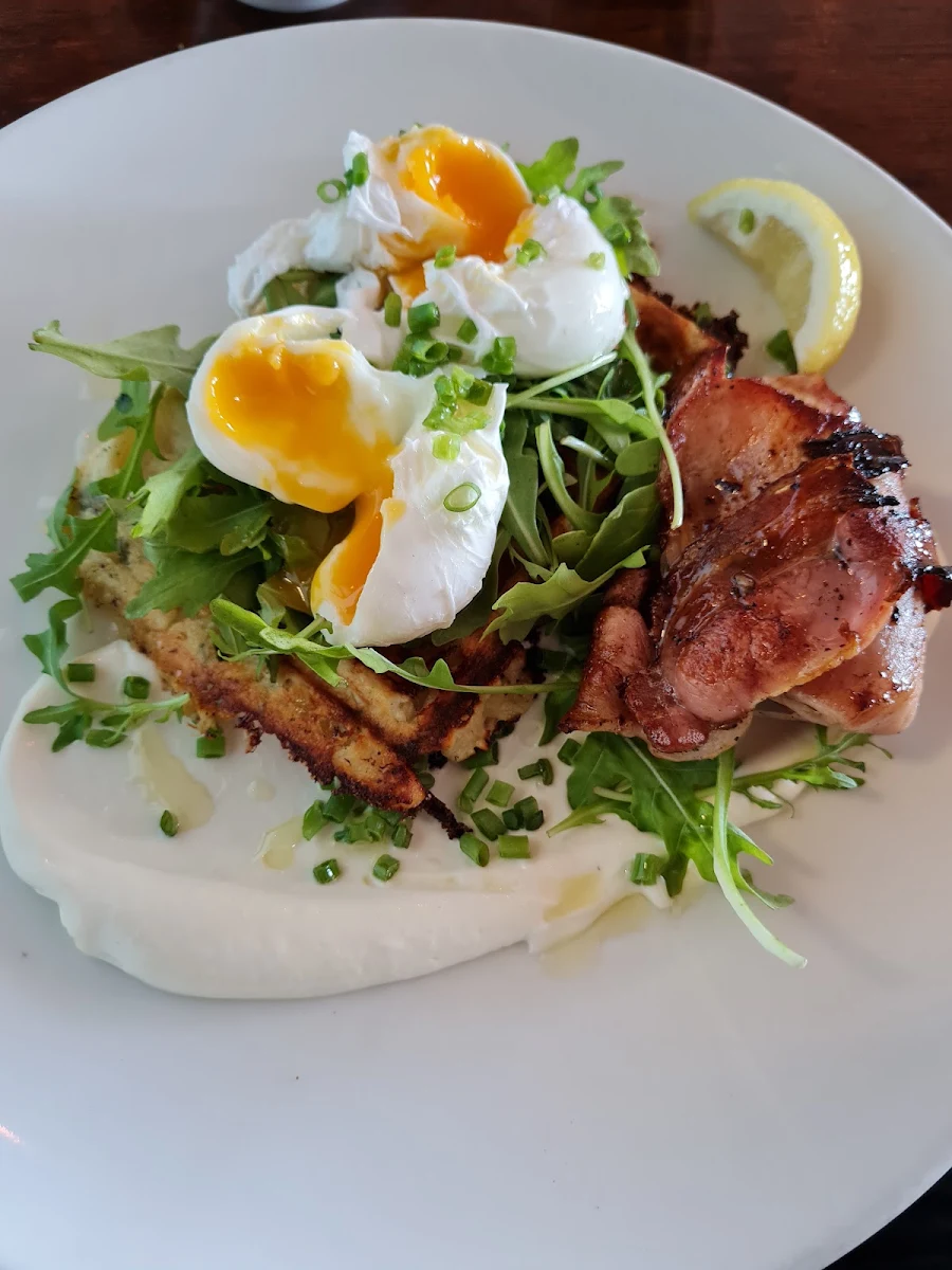 Cheddar and Spring Onion Waffle Crispy Maple Bacon Poached Eggs Leafy Greens with Aioli