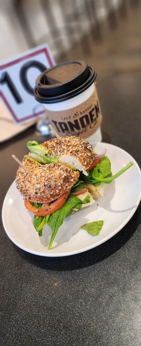 Ham Egg and Cheese Bagel with Tomatoes Onions Spinach Avocado