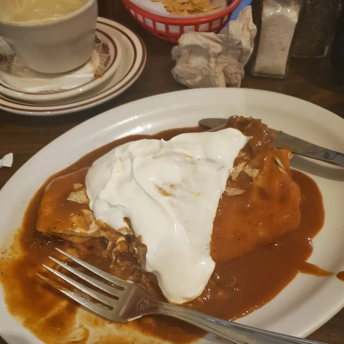 Burrito Topped with Enchalada Sauce and Sour Cream
