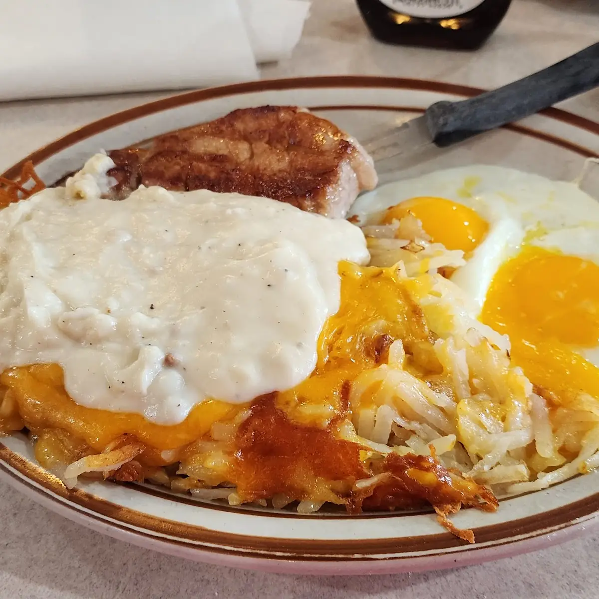 Pork Chop Eggs and Hash Browns Smotheand Coveredred