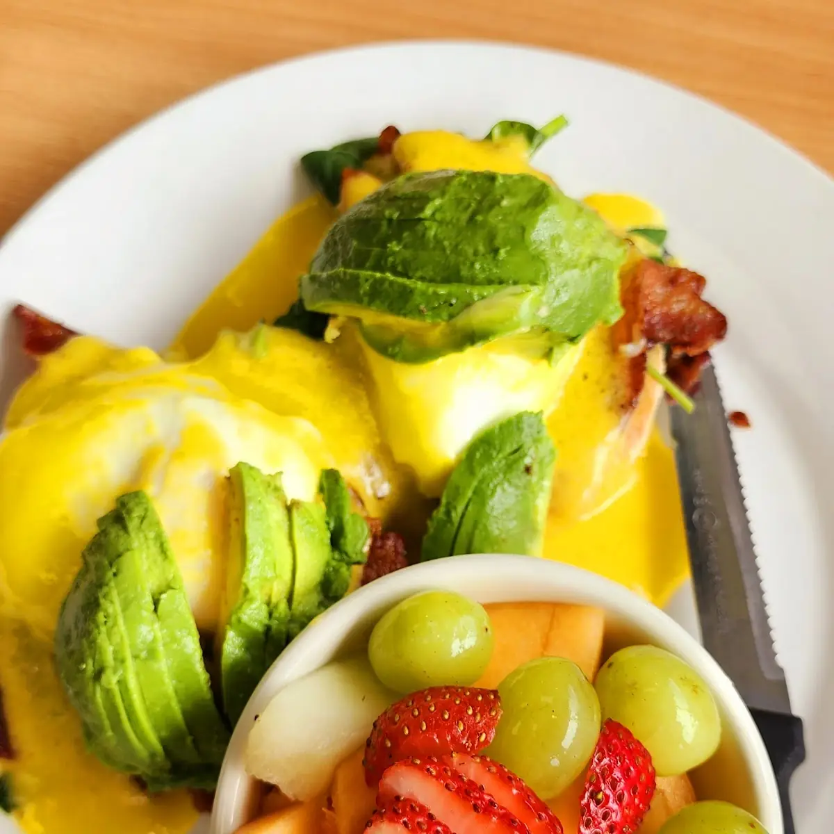 Eggs Benedict Bacon & Avocodo with Fresh Fruit