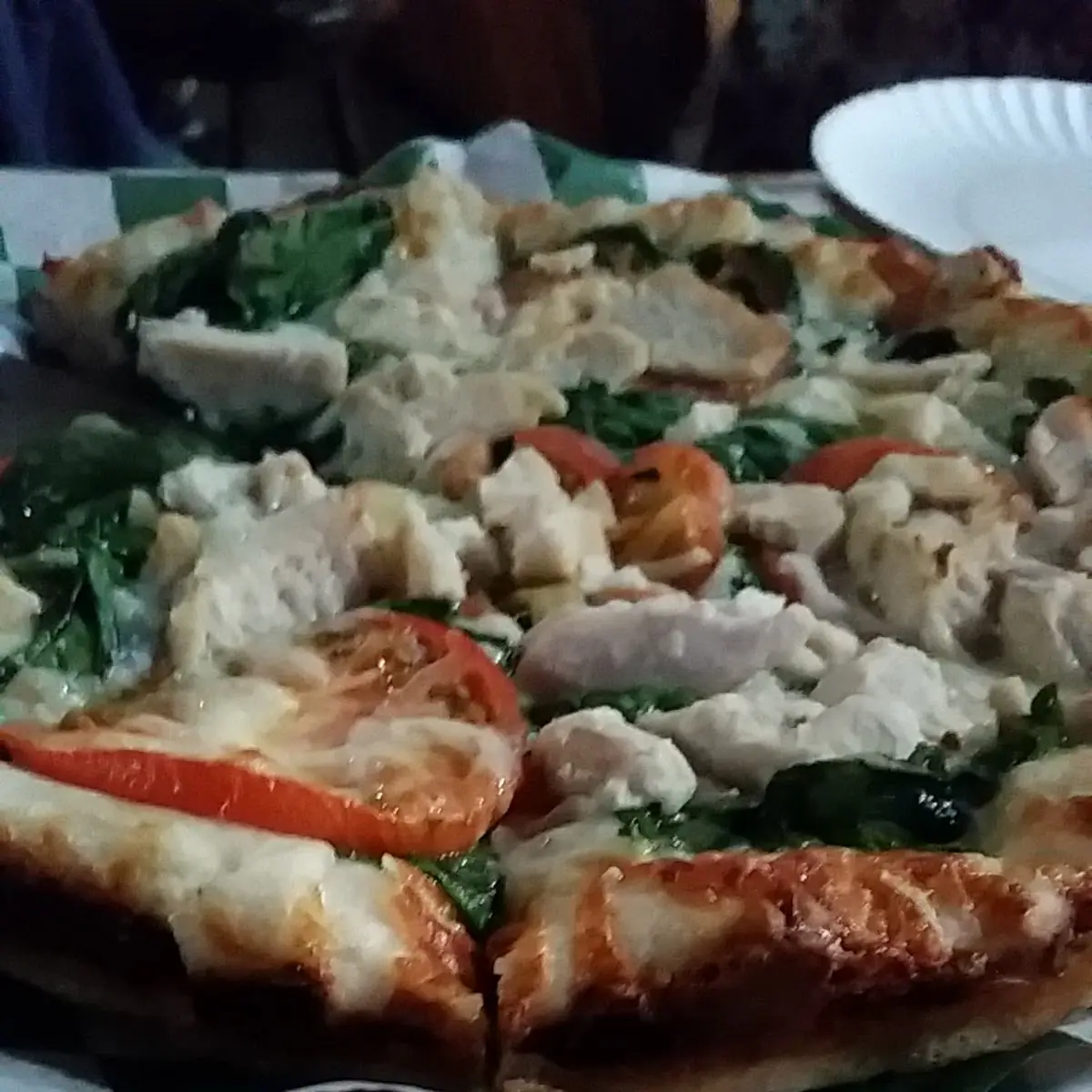 White Pizza Garlic Butter Base Topped with Spinach Tomato and Mozzarella Cheese