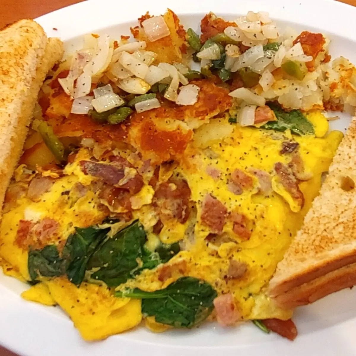 Mixed Grill w Spinach Omelette Hash Browns and Toast