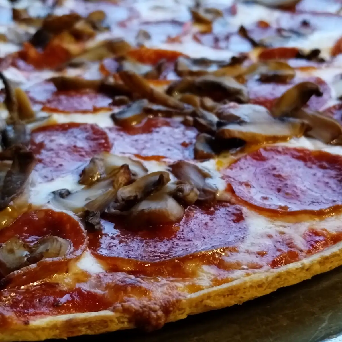 Thin Crust Pizza with Pepperoni and Mushrooms