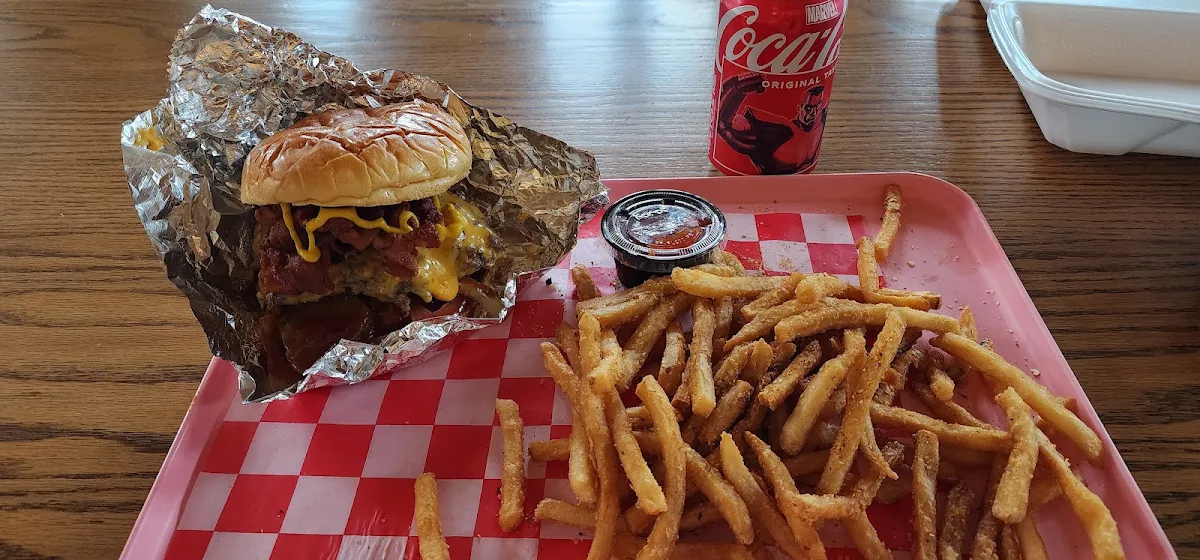 Cheeseburger with Bacon Tomato Onion Pickles and Barbeque Sauce with Seasoned Fries