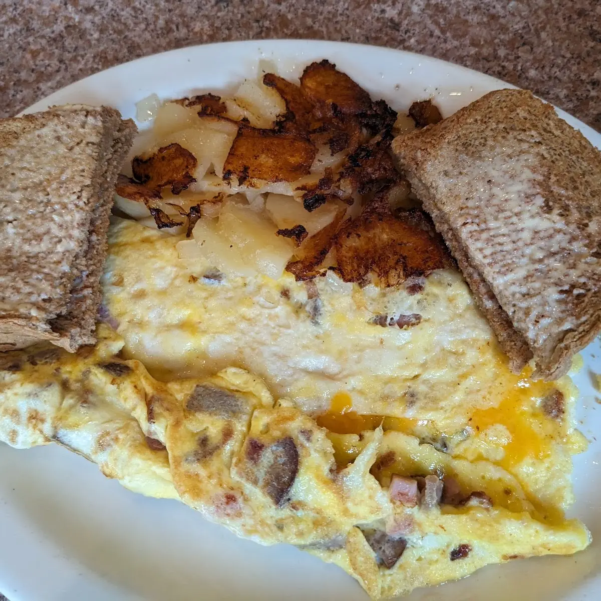 Meat Lover's Omelet with Wheat Toast and Home Style Fries