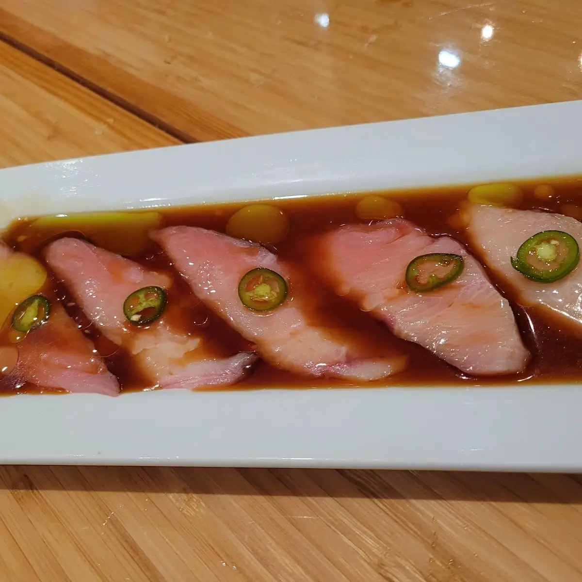 Thin Sliced Hamachi with Traffle Oil Ponzu and Serrano Chile