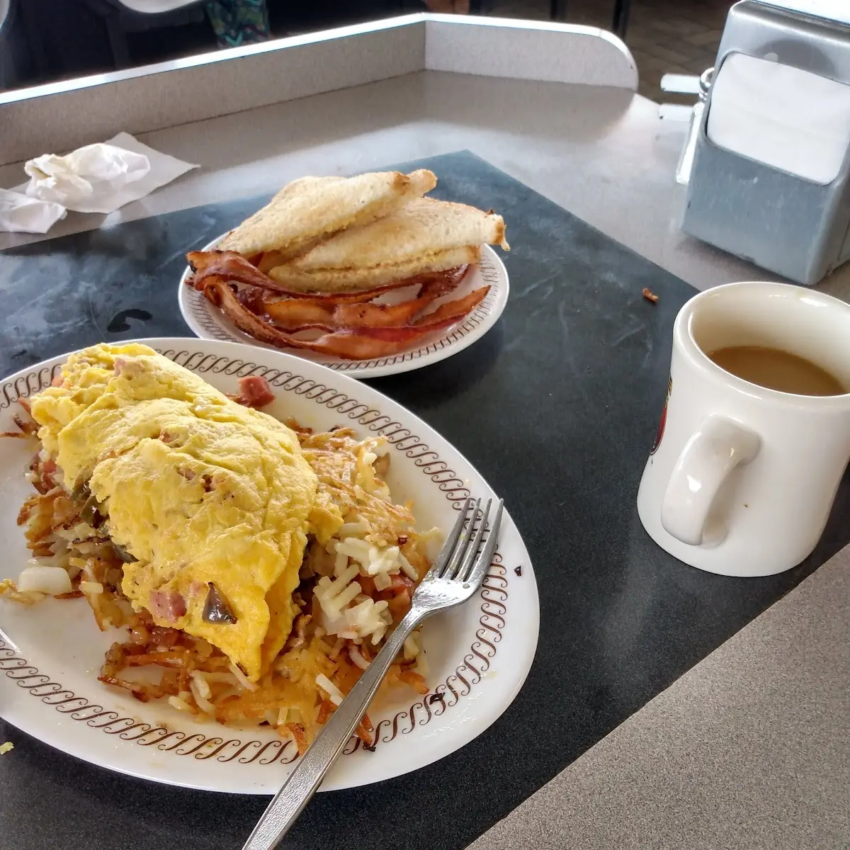 Fiesta Omelet Hash Browns with Tomatoes Onions and Mushrooms Bacon and Gravy on the Side