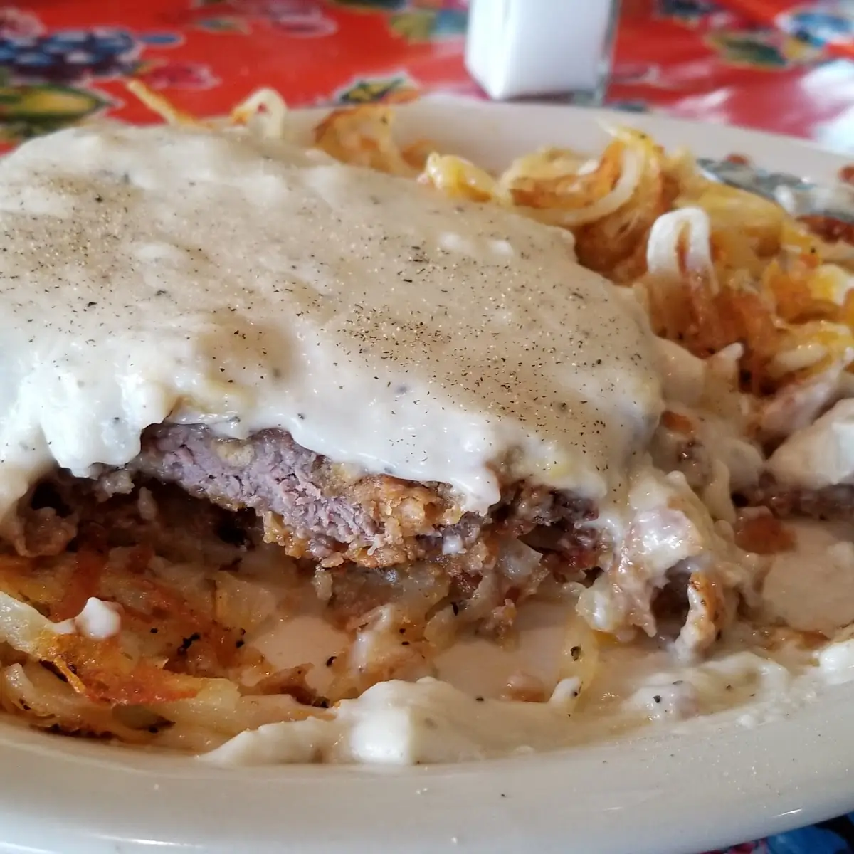 Country Fried Steak with Hashbrowns and Eggs First Cut