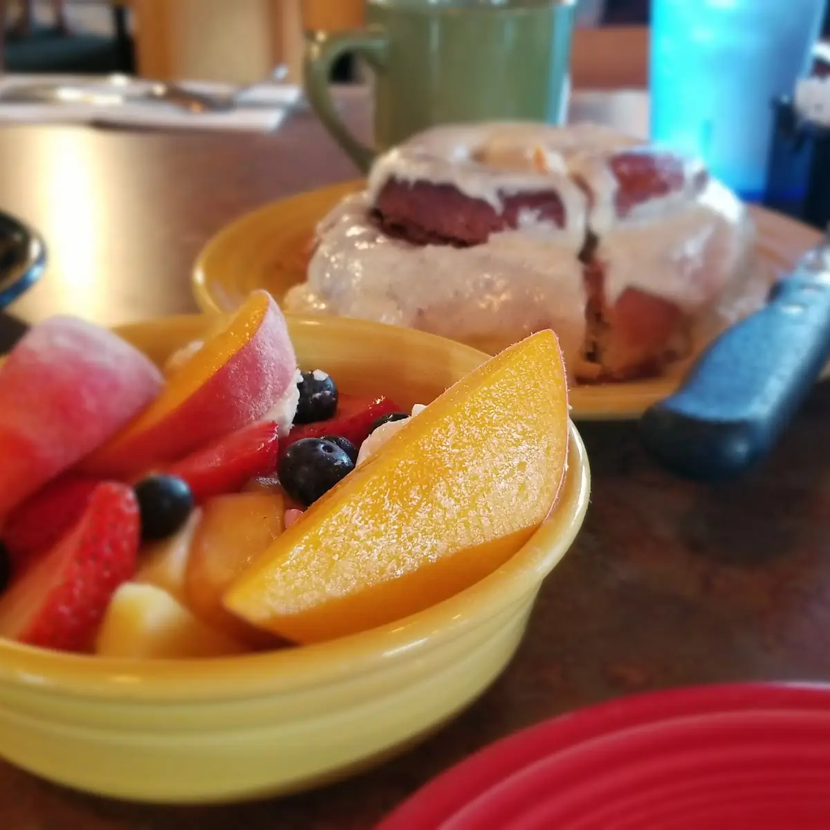 Fresh Fruit Bowl and Cinnamon Roll