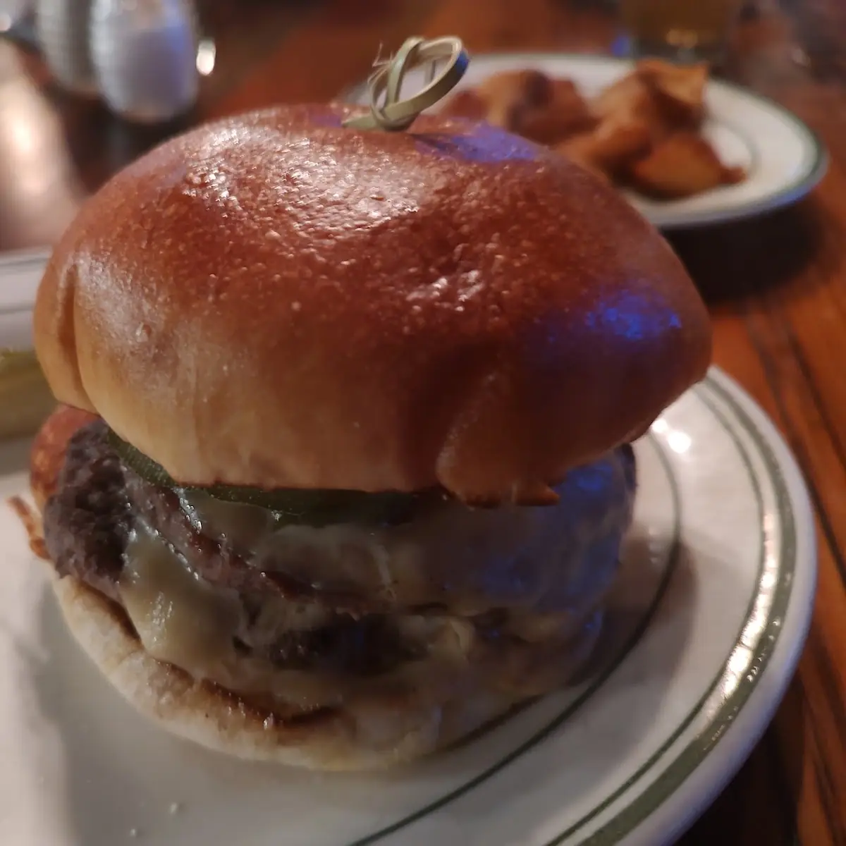 Double Tavern Burger with Smoked Gouda Grain Mustard Grilled Onions on a Brioche Roll