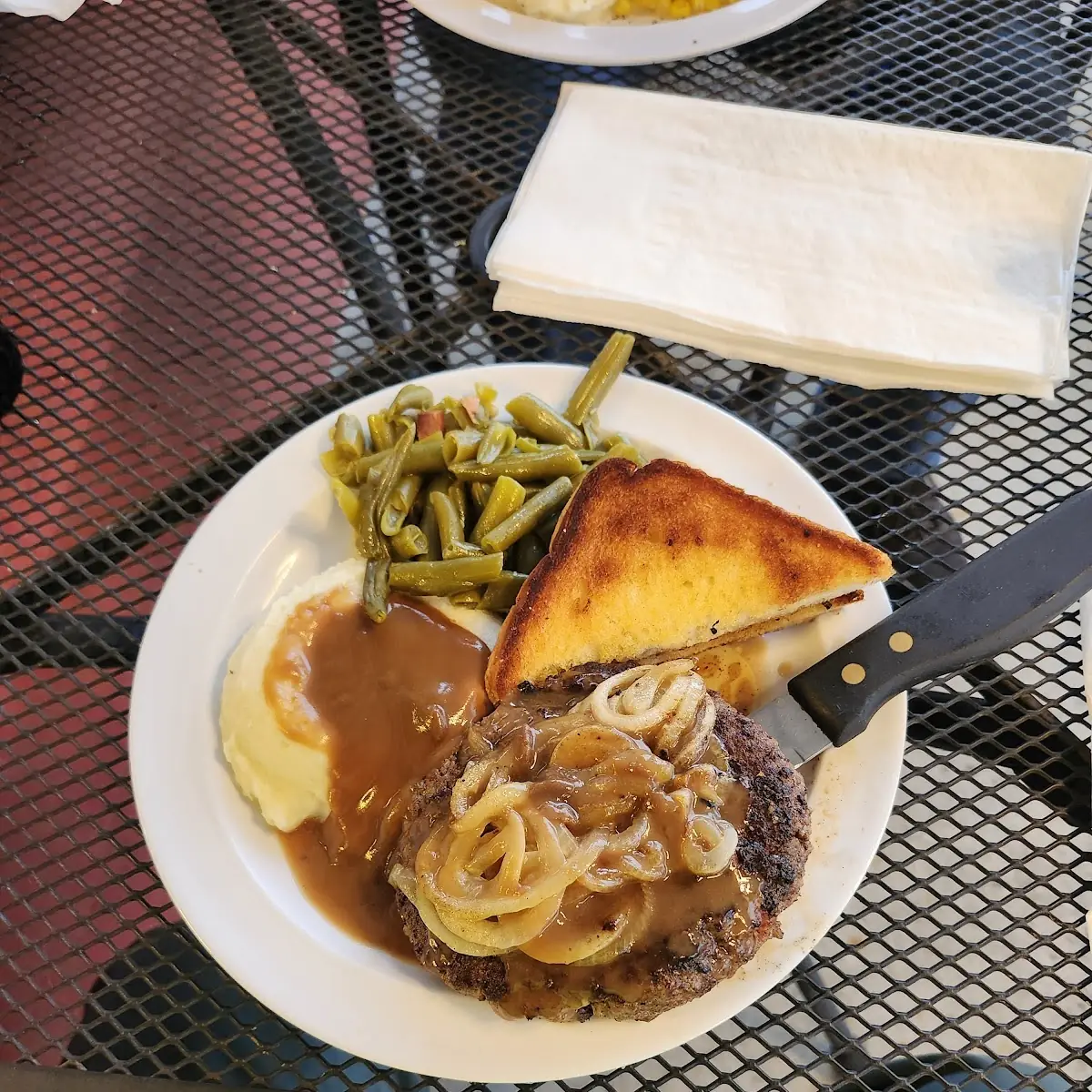 Hamburger Steak with Gravy and Onions Mashed Potatoes and Gravy and Green Beans