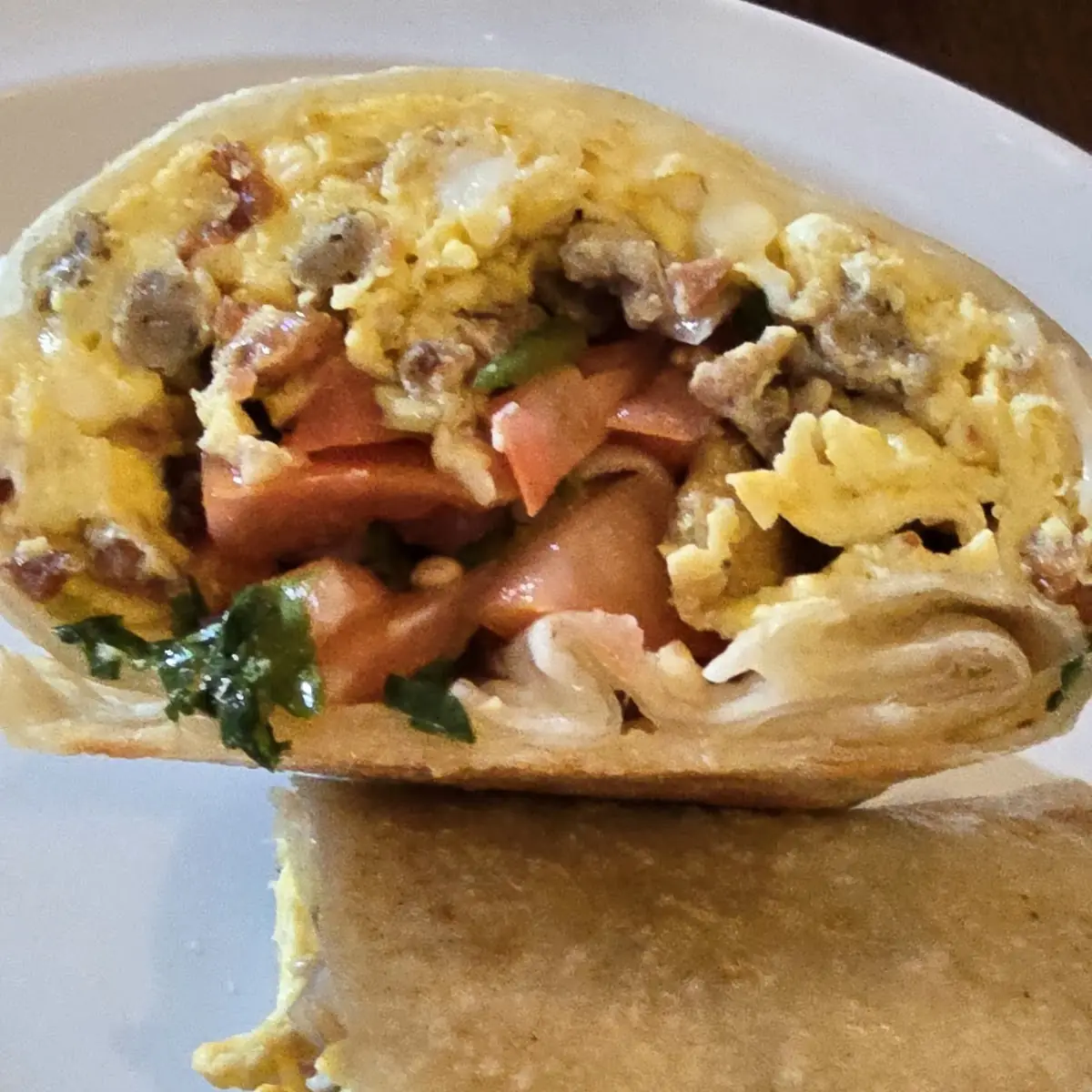 Breakfast Burrito with Bacon Sausage Eggs Cheese Potatoes Pico De Gallo