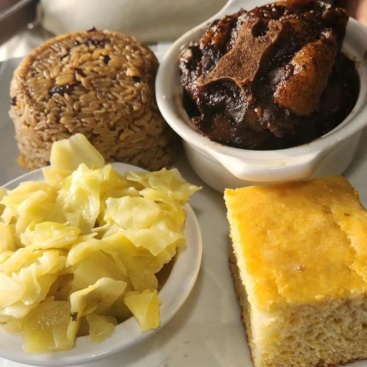 Ox Tails Rice & Peas Cabbage & Corn Bread