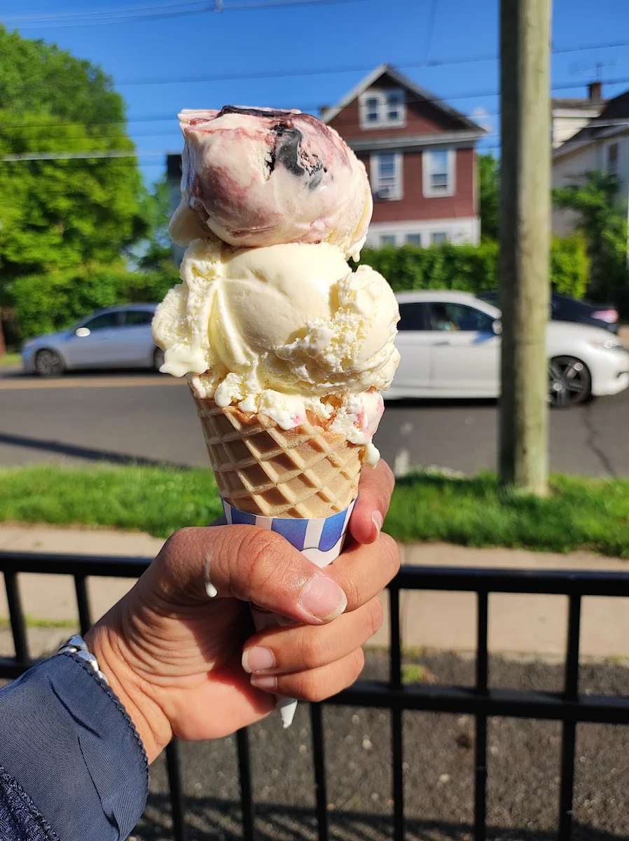 Waffle Cone with Cherry Vanilla Pineapple Coconut and Strawberry Cheesecake Top to Bottom