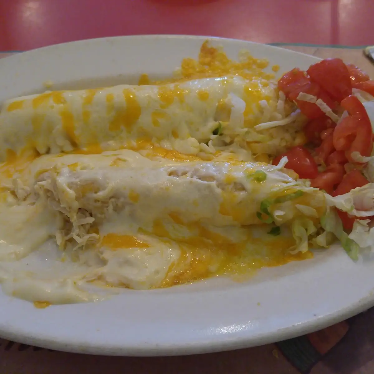 Two Chicken Enchiladas with Spanish Rice and Refried Beans