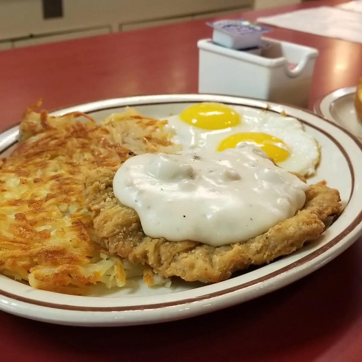 Chicken Fried Steak with 2 Eggs Scrambled and Hash Browns