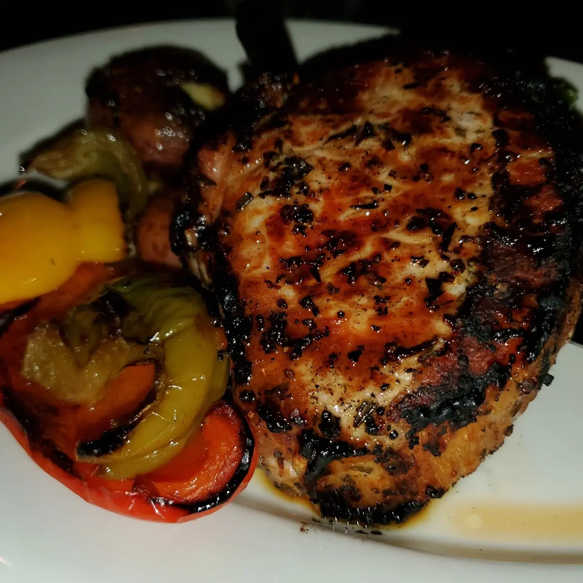 12 Oz Center-Cut Pork Chop with Roasted Peppers Smashed Red Potatoes and Broccoli