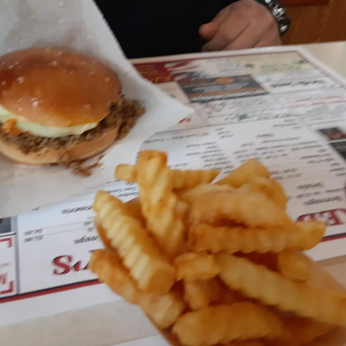 French Fries with Hamburger in Background