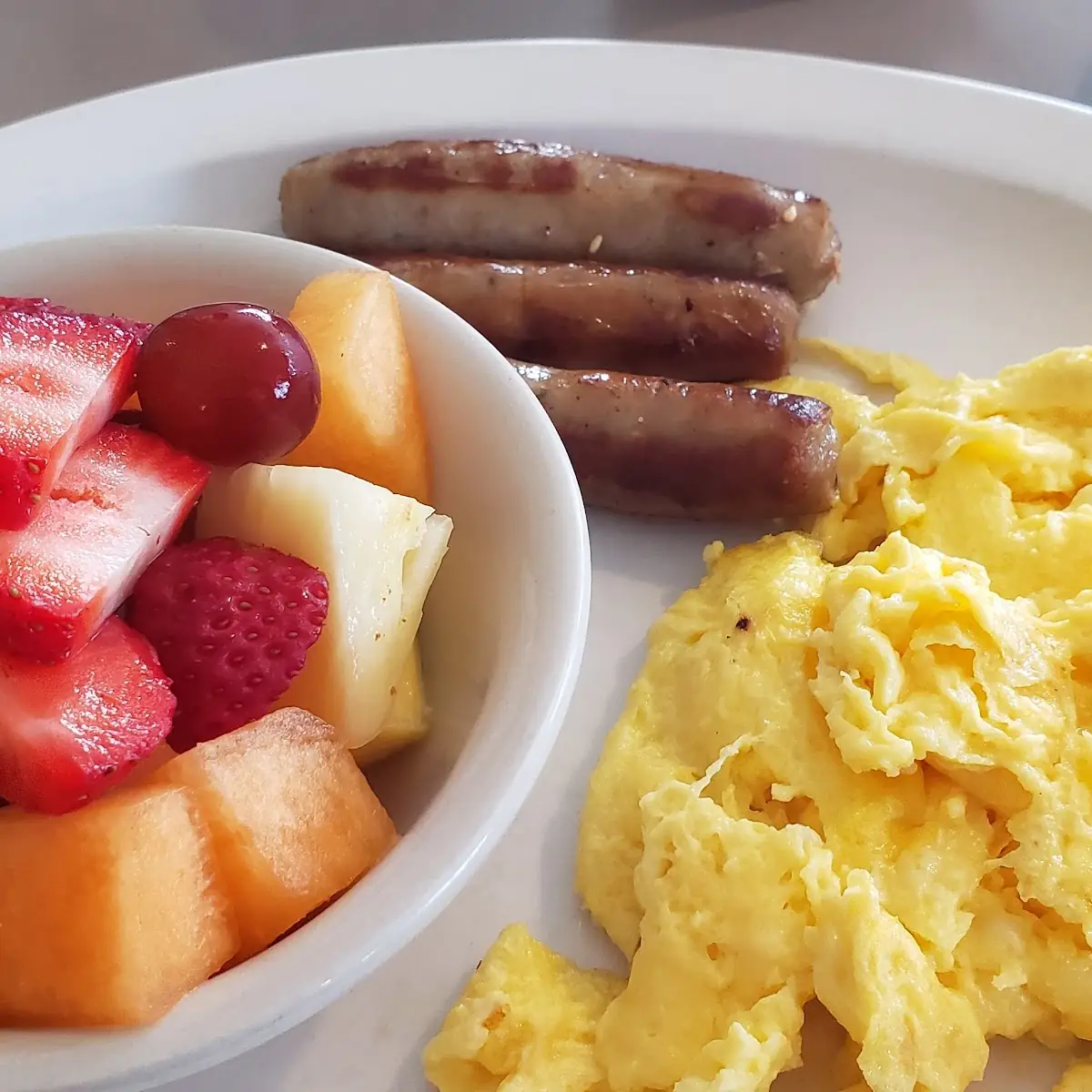 2 Scrambled Eggs Sausage Links Fruit and Toast