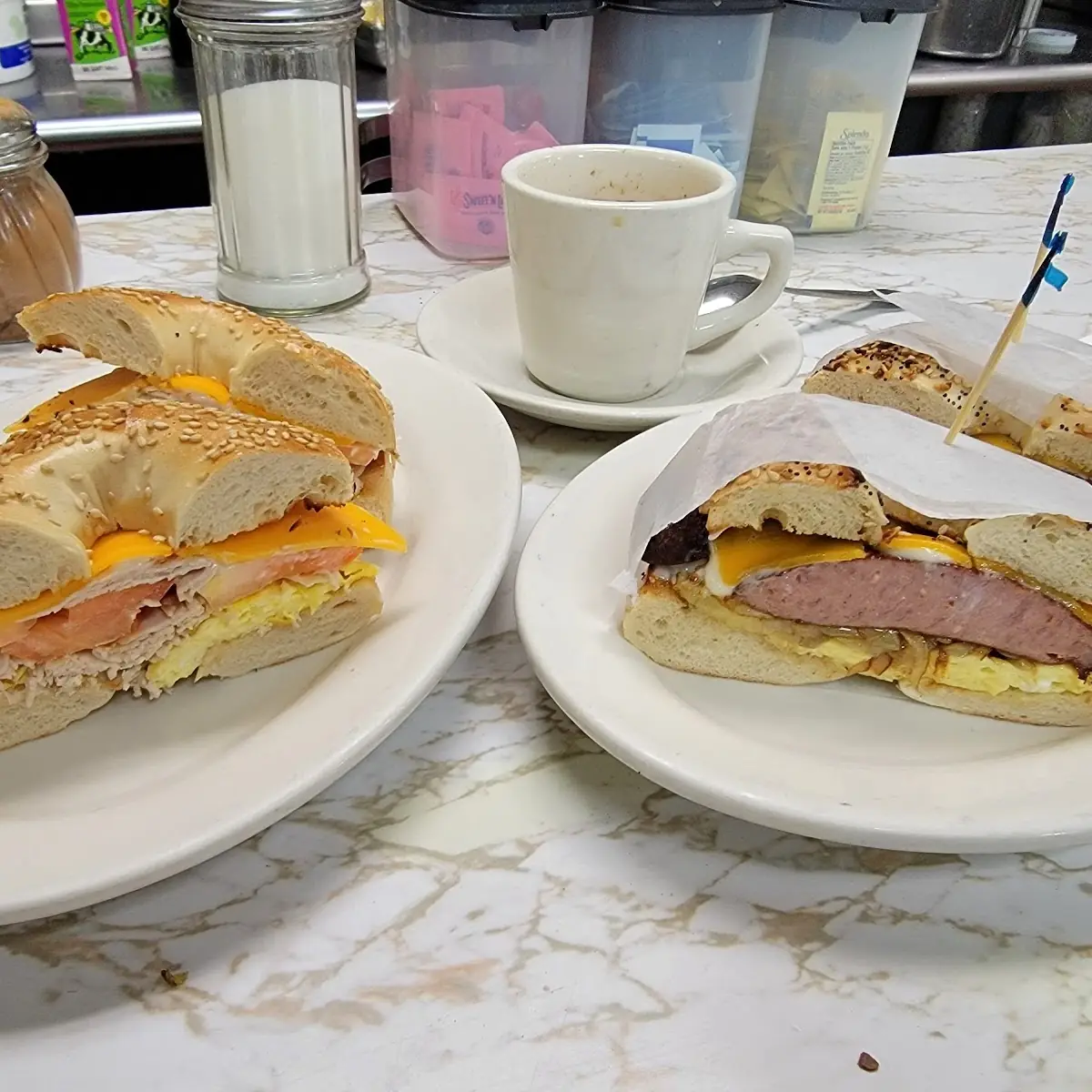 Scambled Eggs Grilled Onions Turkey Sausage & Cheaddar on an Everything Bagel