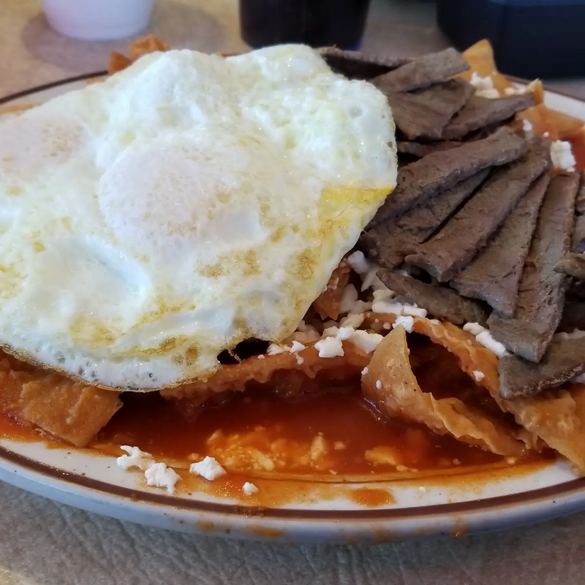 Chilaquiles Rojos with Steak and over Easy Eggs