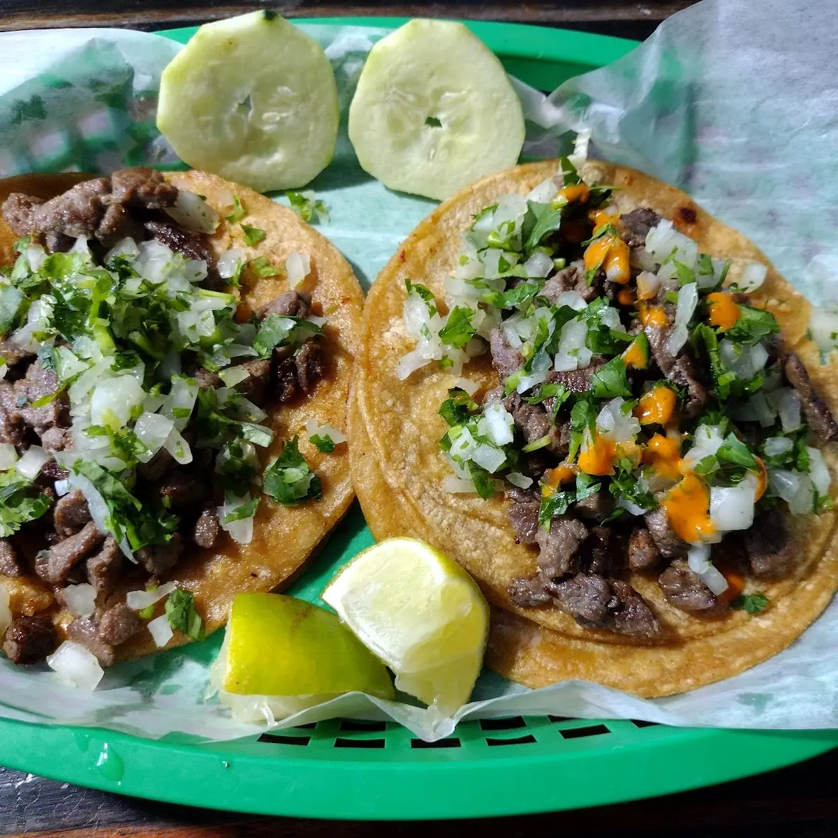 2 Steak Tacos Right Has a Line of Red Hot Sauce