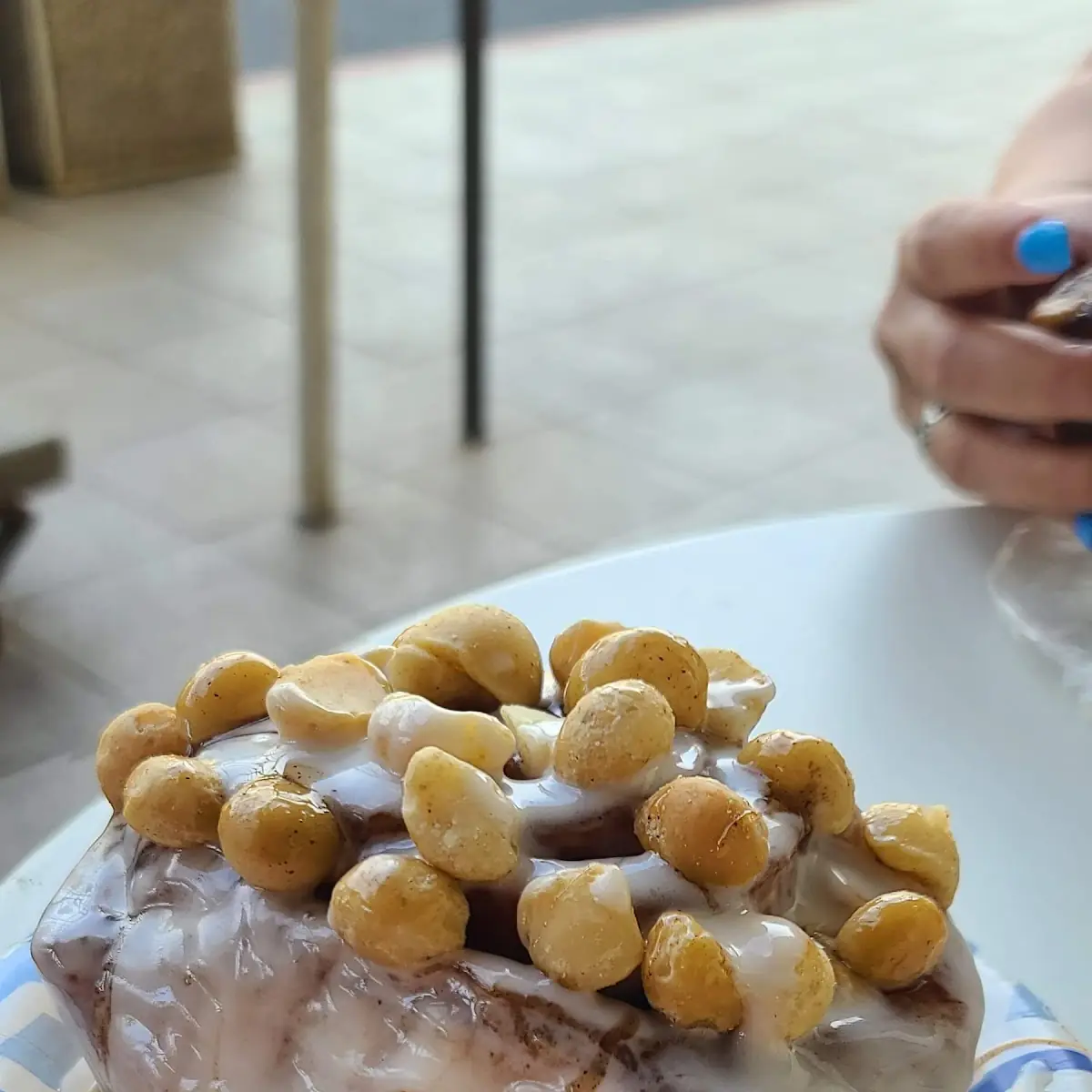 Cinnamon Roll with Frosting and Macadamia Nuts