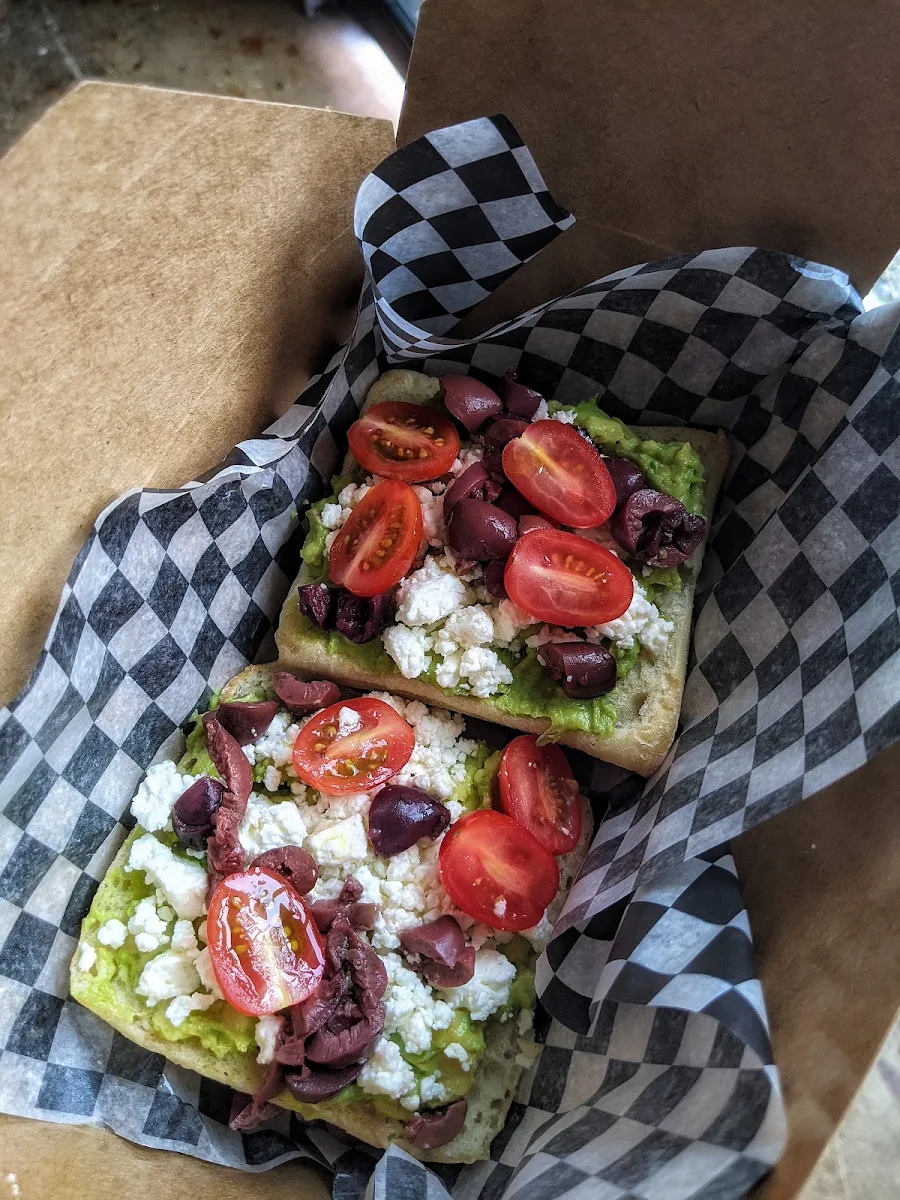 Avacado Toast with Feta Kalamata Olives Tomatoes and a Drizzle of Olive Oil