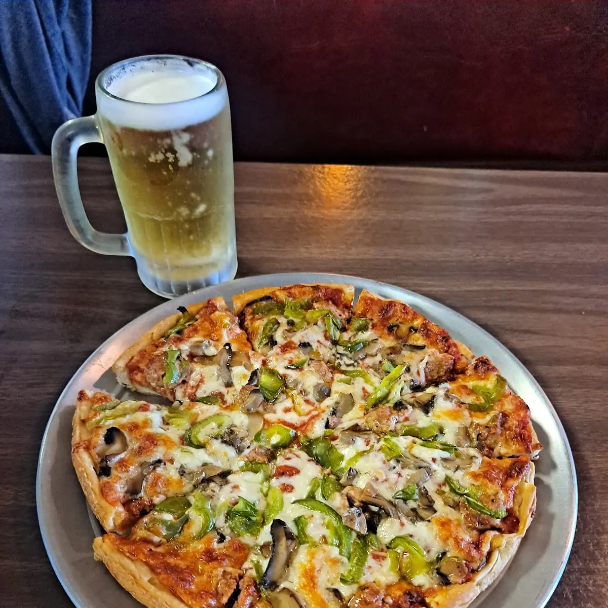 Sausage Mushroom and Peppers Pizza with a Draft Beer
