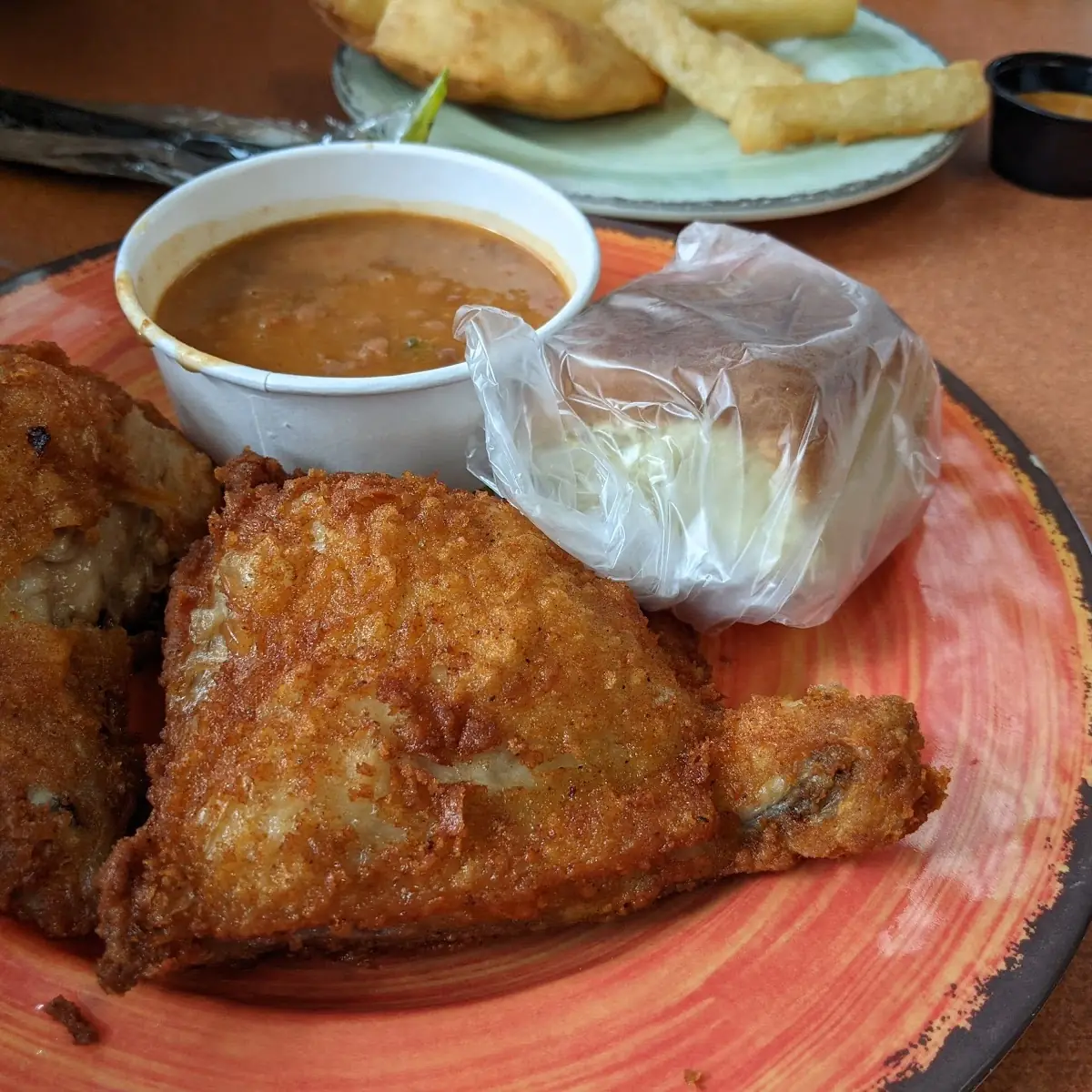 Fried Chicken with Dinner Roll and Side of Beans