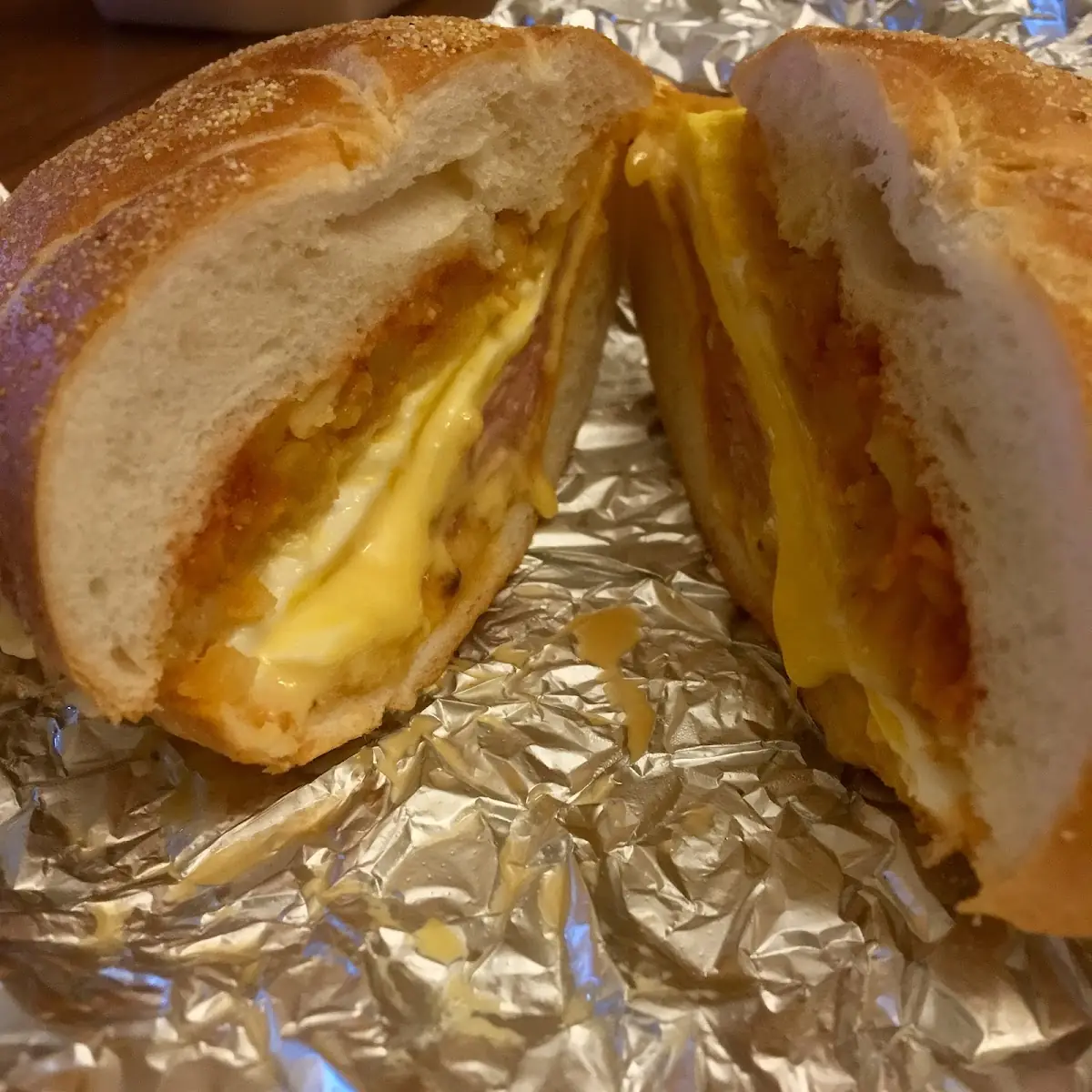 Bacon Egg Cheese and Potatoes on a Hard Roll