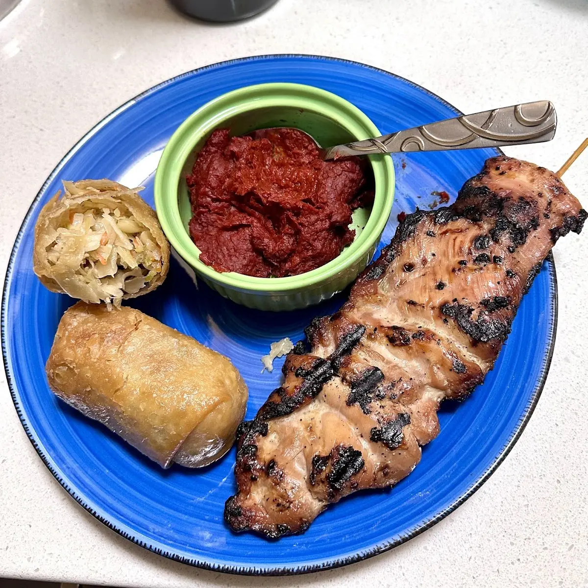 Egg Rolls and Chicken Skewers Served with Chili Paste