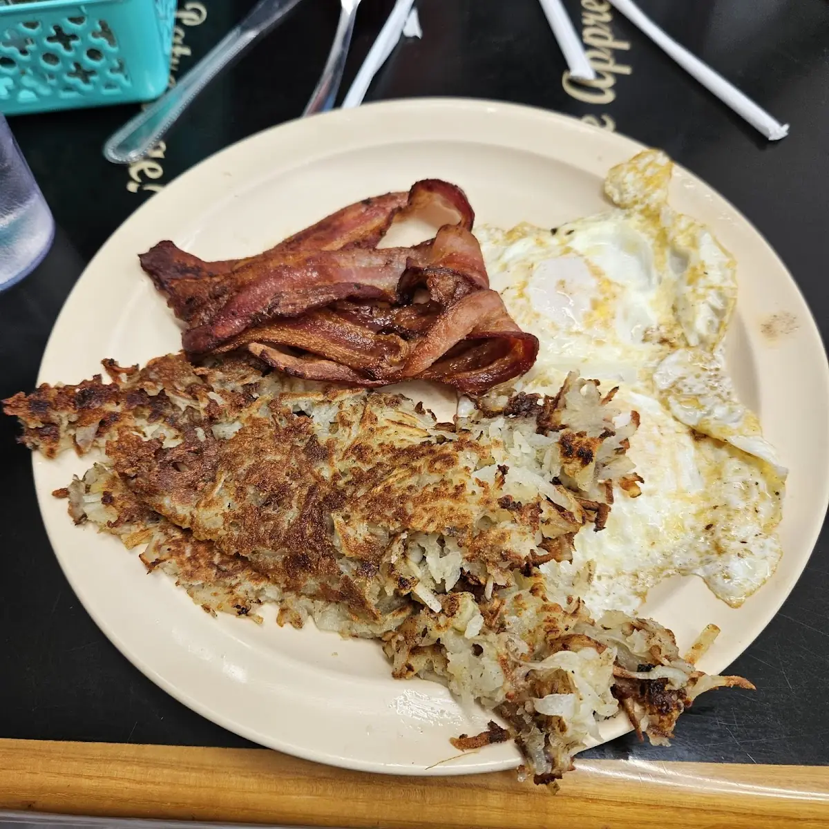 Four Eggs over Medium Hash Browns Bacon and Toast