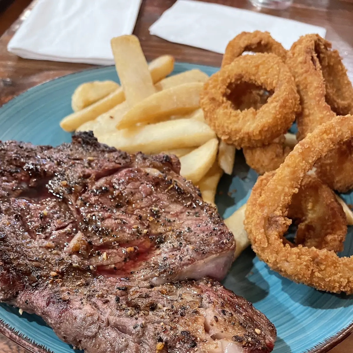 Rib Eye Steak with Onion Ring and Fries