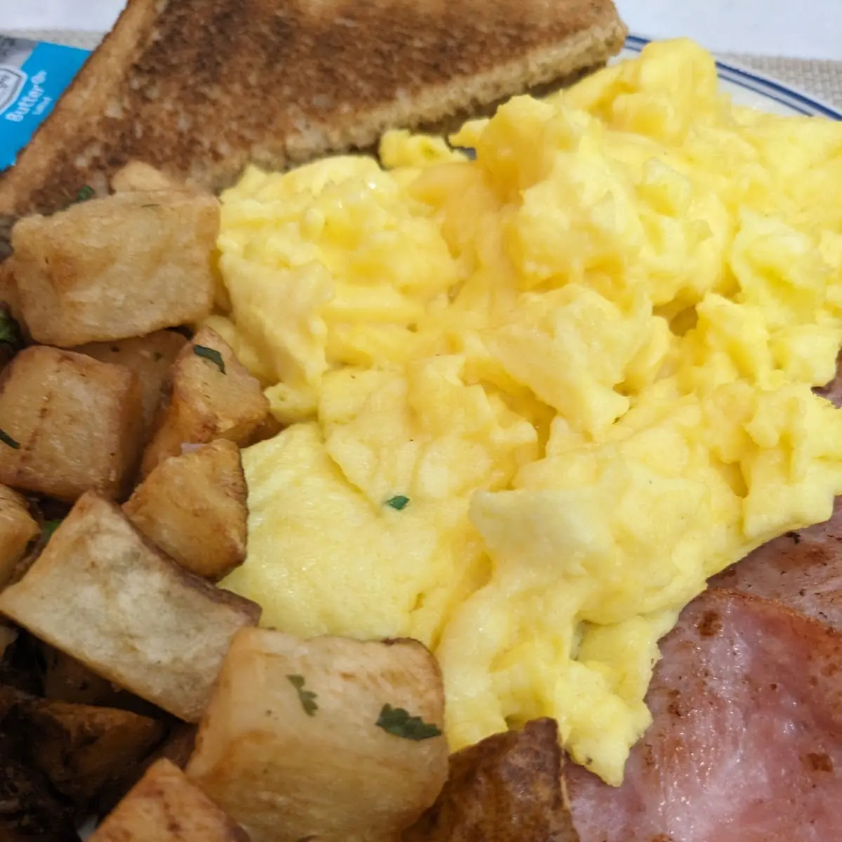 Scrambled Eggs with Breakfast Potatoes and Canadian Bacon