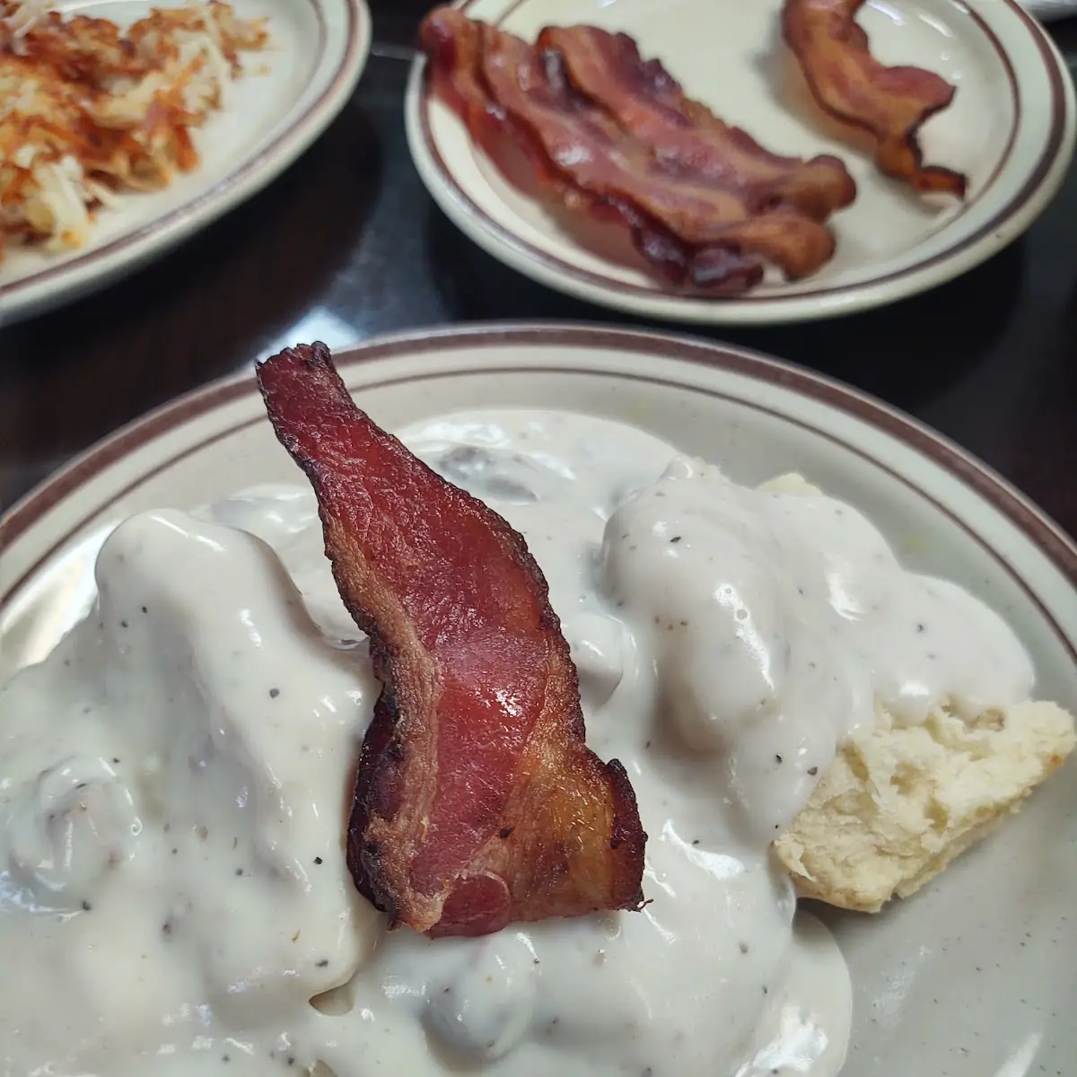 Biscuits and Sausage Gravy with Crispy Bacon and Hash Browns