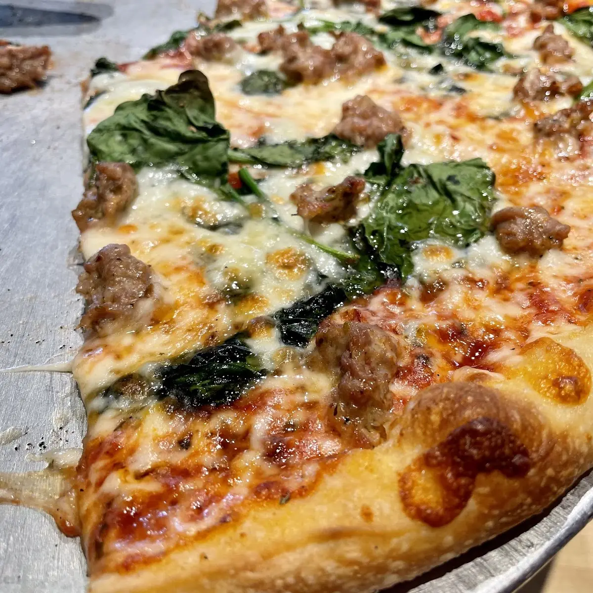 Spinach and Sausage Pizza Slice