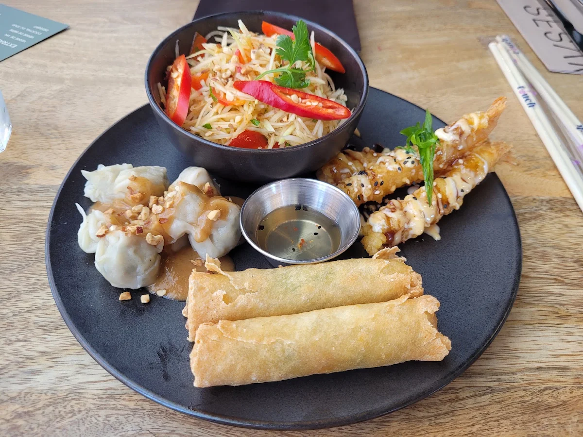 Entre Sampler if Papaya Salad Spring Rolls Tempura Shrimp and Peanut Butter Dumplings