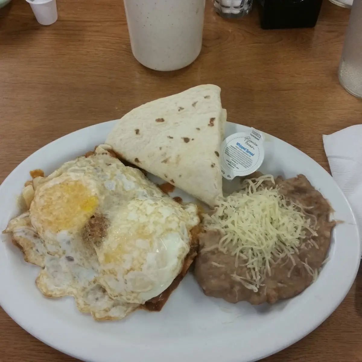 2 Enchiladas 2 Eggs and Refried Beans