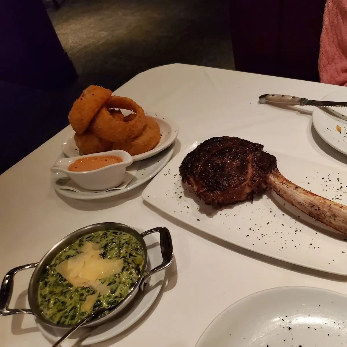 Sauteed Spinach Onion Rings and Tomahawk Ribeye