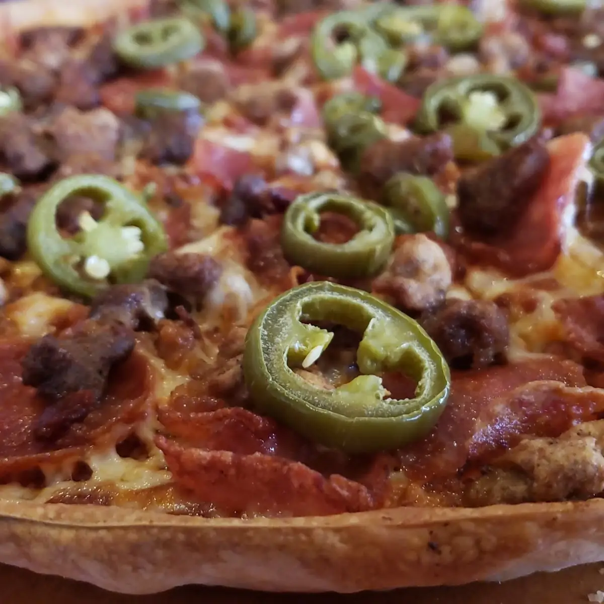 Thin Crust Meat Lovers Pizza with Jalapeno Peppers