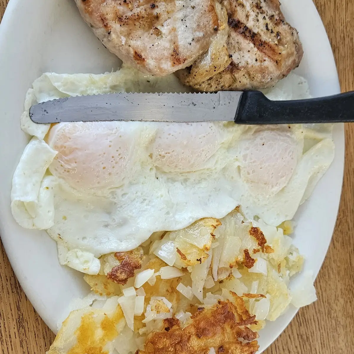 Eggs with Porkchops Hashbrowns with Grilled Onions