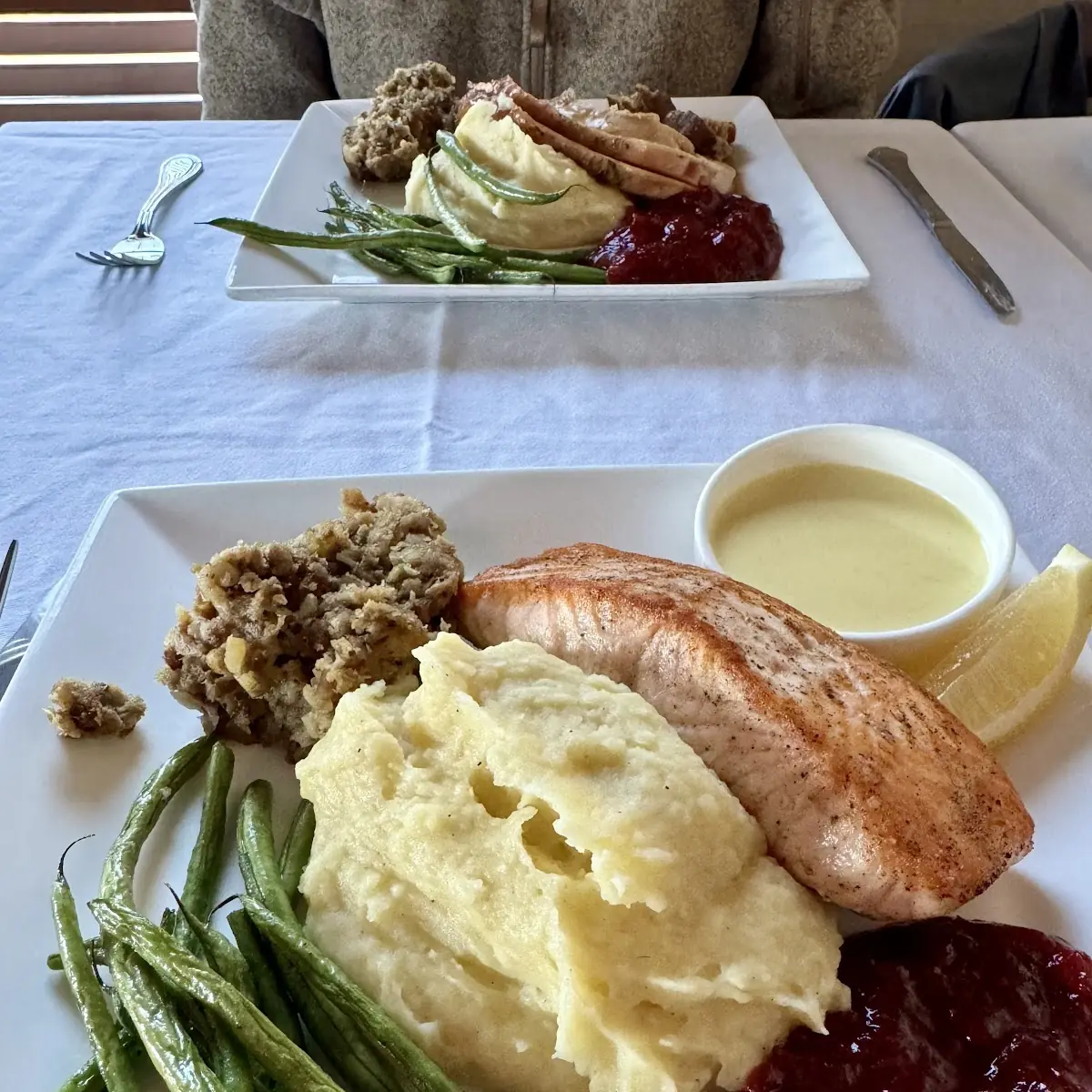 Salmon Mashed Potatoes Pork Stuffing Green Beans Cranberry Compote Saffron Cream Sauce