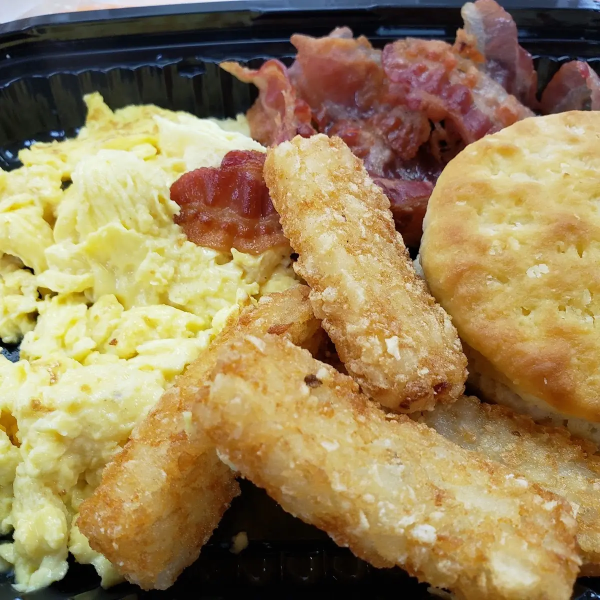 Breakfast Platter with Scrambled Eggs Bacon Hasbrouck Sticks and a Biscuit