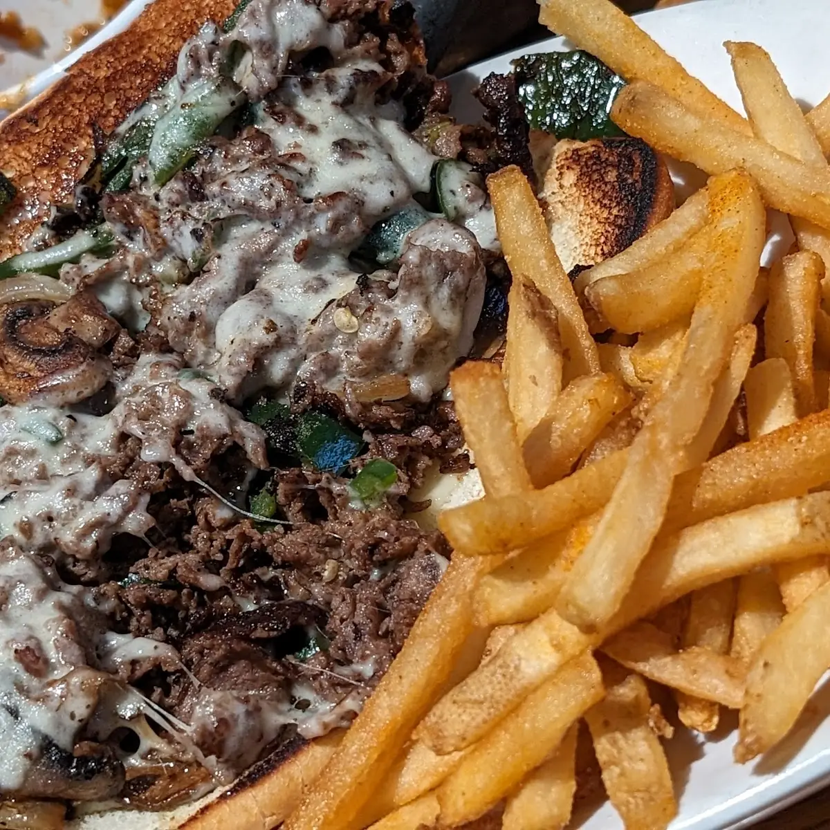 Philly Cheesesteak Sandwich and Fries