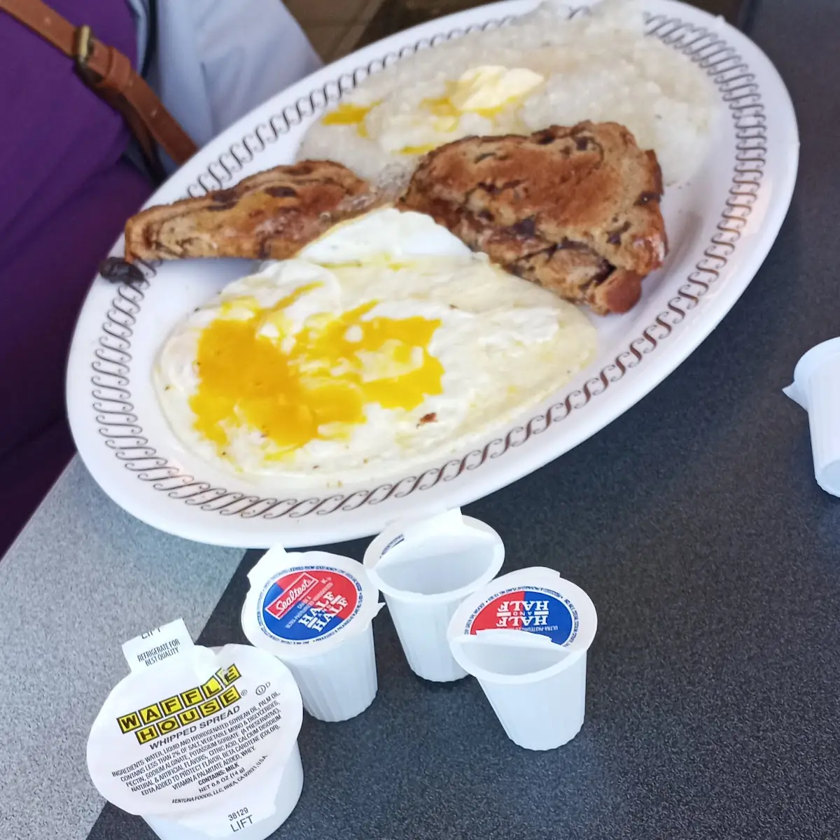 2 Eggs over Medium Grits and Raisin Toast