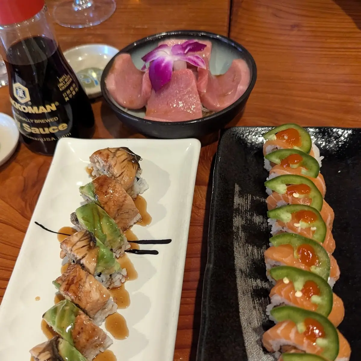 Top Toro Sashimi Left in N Out Roll Right Dragon Roll